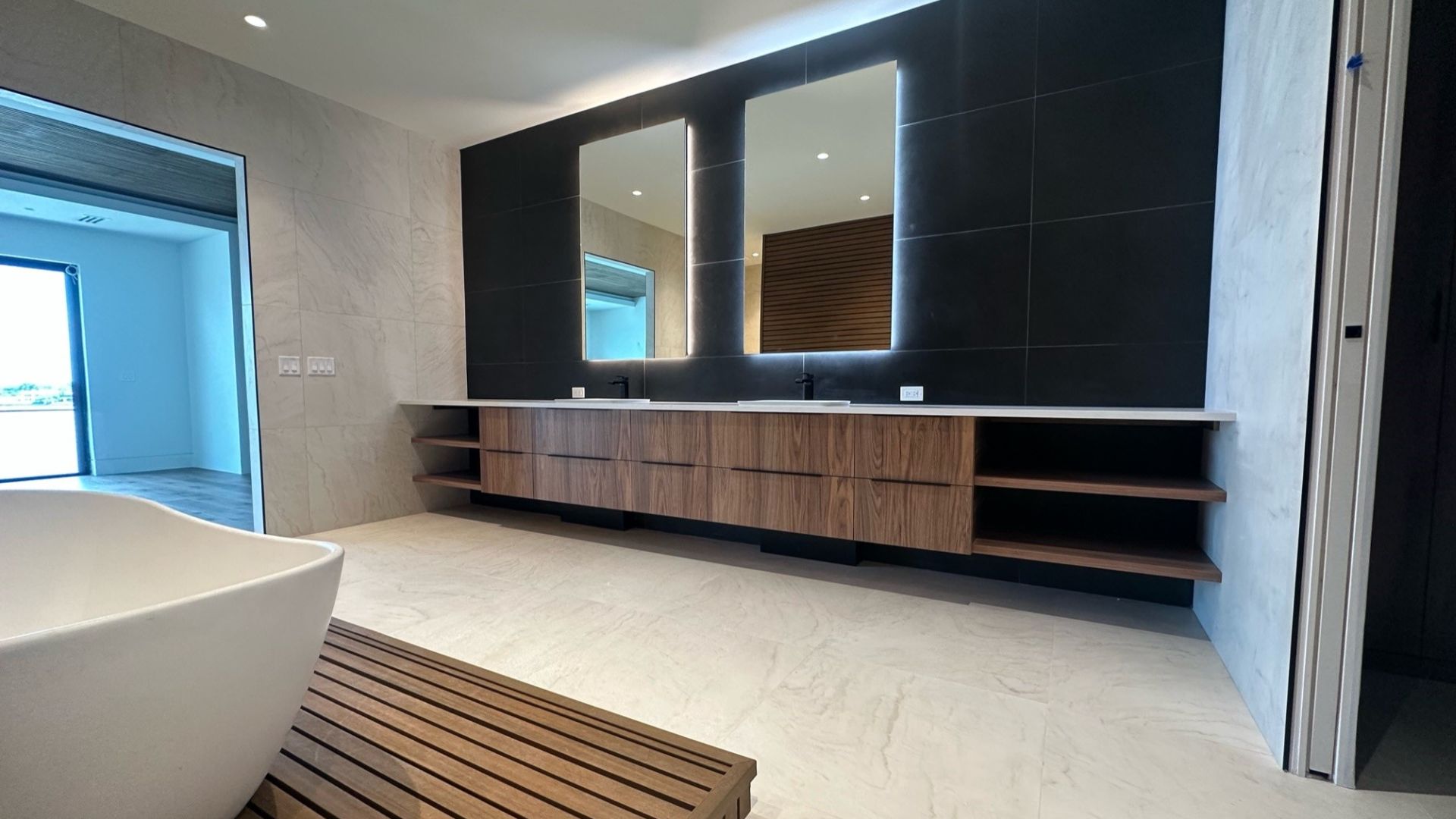 Contemporary bathroom featuring black cabinets, minimalist fixtures, and a sleek modern design