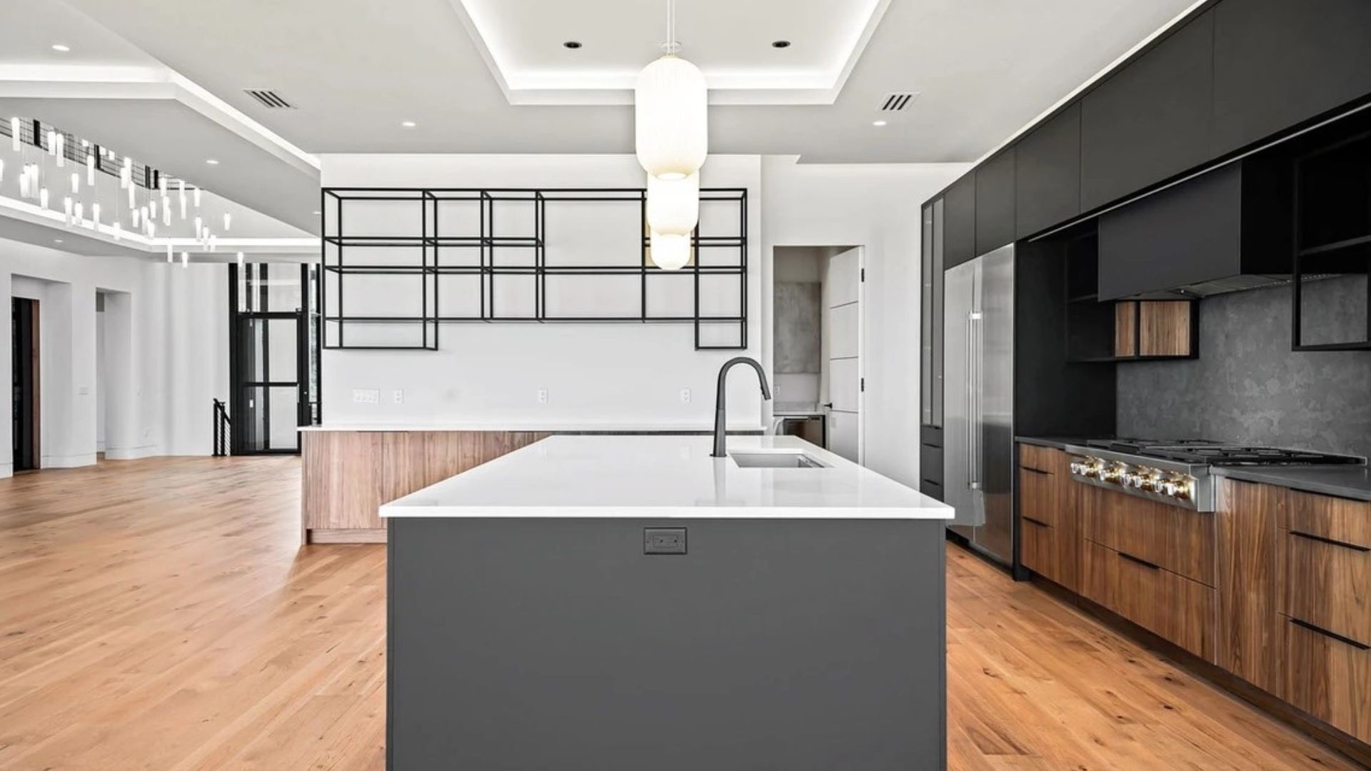 Side View of White island Kitchen with black cabinets