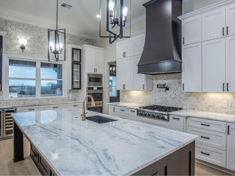 Modern Kitchen with White Cabinets and Black Island Countertop Modern Bathroom with White Vanity and Wooden Shelves