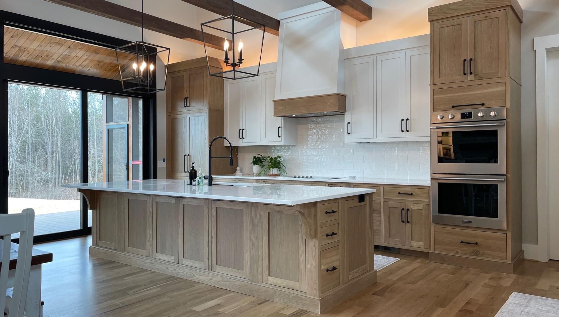 White Kitchen with Brown Bell Cabinet A white kitchen featuring a brown cabinet with a bell-shaped design, adding a unique and elegant touch to the space.
