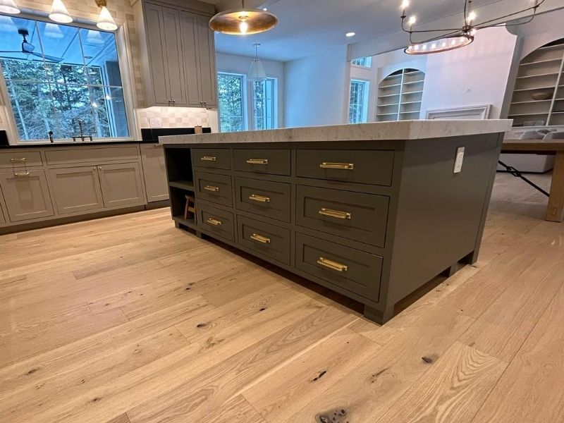 Green island with gold handlers and gray cabinets Green island with gold handlers and gray cabinets