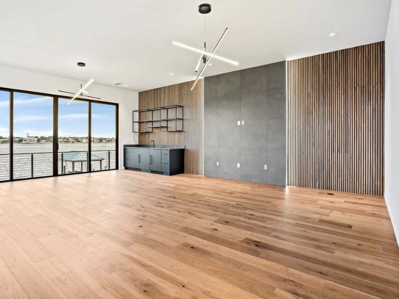 Kitchen with Light Wood Flooring and Modern White Cabinets